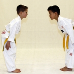 Two students bow to one another to show their respect and courtesy to one another