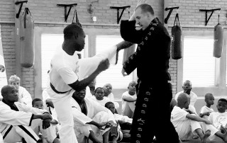 Warren Vice teaching a young man in Africa